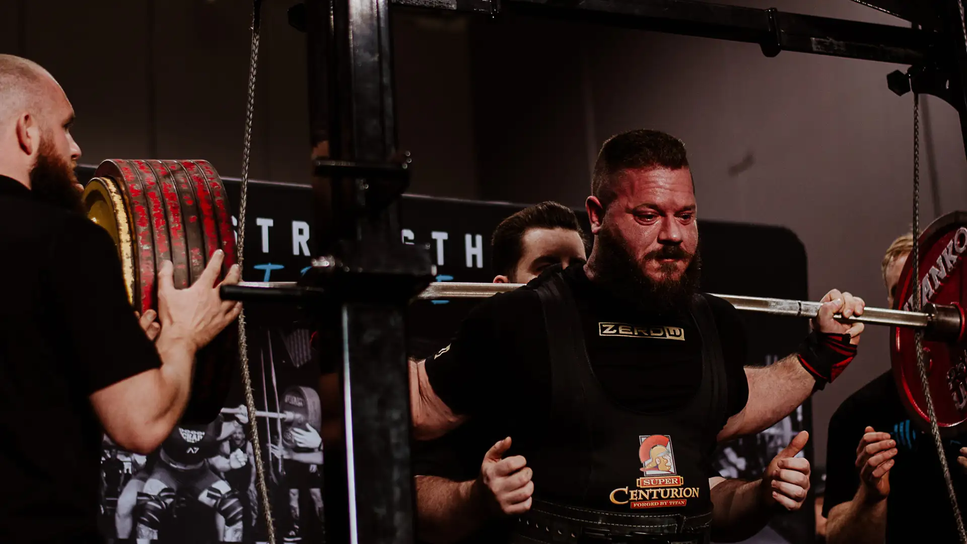 Powerlifter in a ZeroW singlet squatting at a powerlifting competition