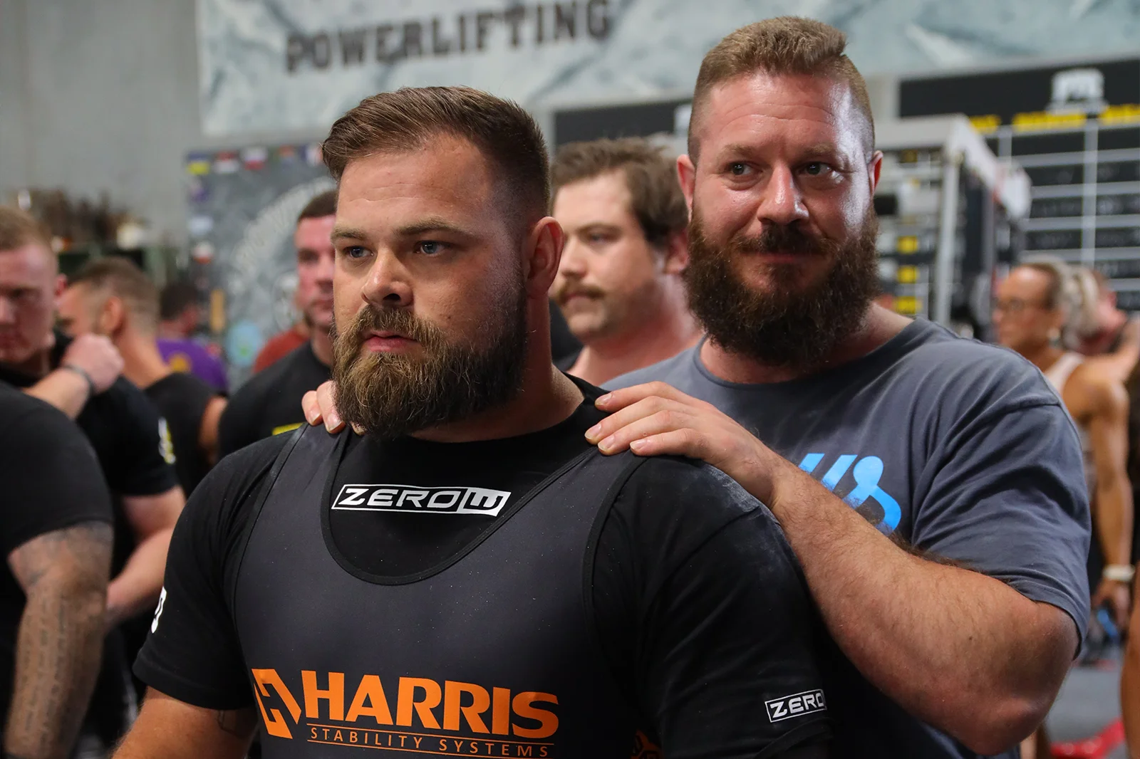 Online powerlifting technique coaching — ZeroW coach delivering a technical cue on the platform