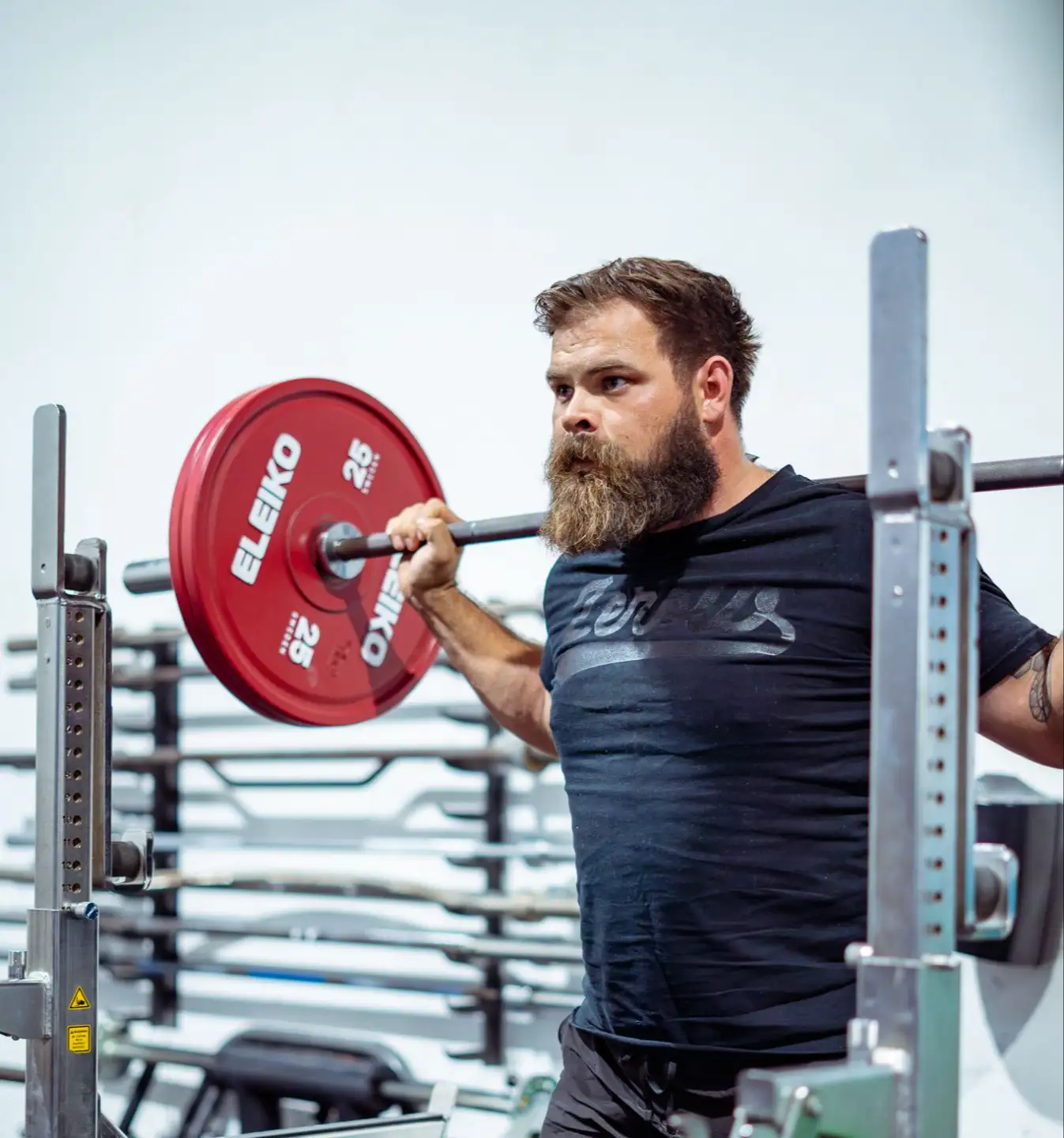 Powerlifter performing a back squat with Eleiko plates — ZeroW App training blocks
